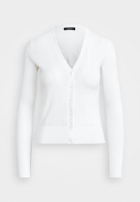 Balta garām piedurknēm kardigāna jakas izgatavota no mīksta auduma. Tam ir V veida kakla izgriezums un rinda no sešām saskaņotām pogām priekšā. Īsa piegriezuma.