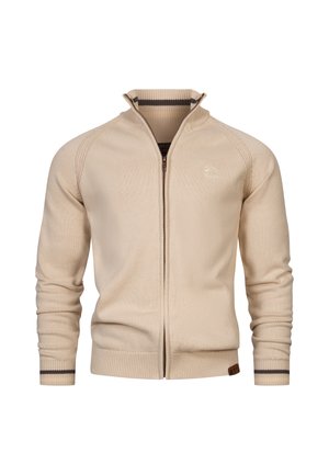 Béžový pletený sveter na zips s vysokým golierom a tmavým pruhom na manžetách, rebrovaným lemom a jemným logom na ľavej hrudi.