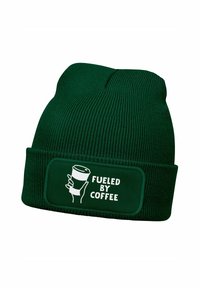 Green knit beanie with a folded cuff; features a horizontal patch with a graphic of a hand holding a coffee cup and the text "FUELED BY COFFEE."