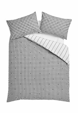 Schwarz-weiß kariertes Gingham-Bettbezug und Kissenbezüge mit kleinen Herzdetails, wendbar auf eine weiße Seite mit gepunkteten Linien.