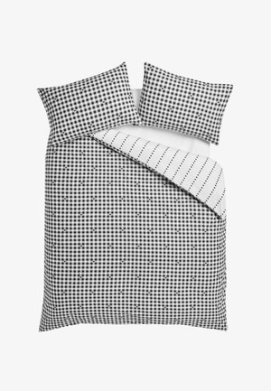 Schwarz-weiß kariertes Gingham-Bettbezug und Kissenbezüge mit kleinen Herzdetails, wendbar auf eine weiße Seite mit gepunkteten Linien.