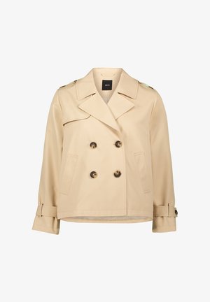 Beige double-breasted trench coat with large buttons, shoulder epaulettes, and side pockets. Made from smooth, lightweight fabric.