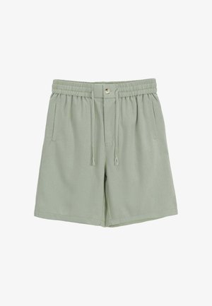 Shorts vert clair à taille élastique avec cordon, fermeture par bouton et poches latérales sur fond blanc.