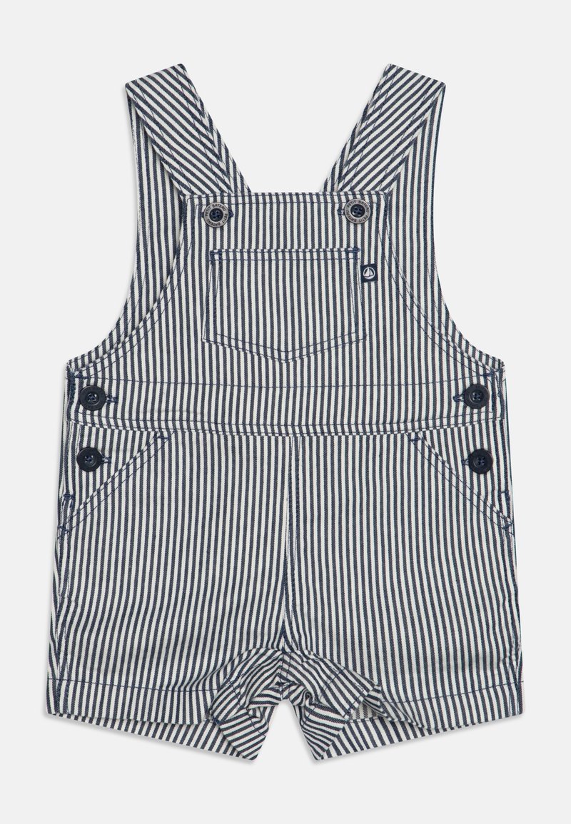 Salopette courte pour tout-petit rayée verticalement bleu marine et blanc, avec poche avant, bretelles boutonnées et fermetures latérales à boutons.