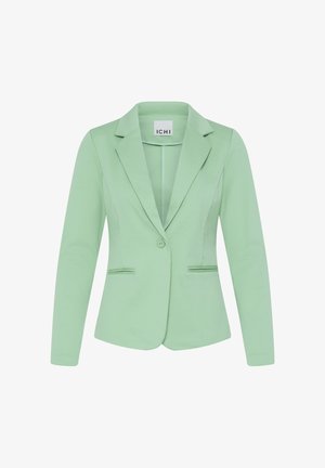 Lichtgroene, op maat gemaakte damesblazer met lange mouwen, enkele knoopsluiting, notch revers en twee voorzakken met paspel.