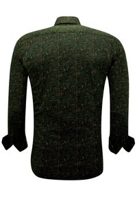 Langsleeve shirt van donkergroene stof met een geometrisch patroon in goud en lichtbruin. Standaard kraag en knoopmanchetten.