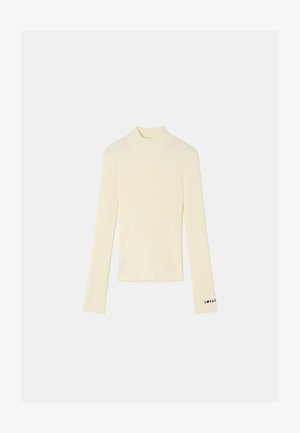 Ribbet, langermet turtleneck topp i lys gul, med en tettsittende design og svart akcenttekst på mansjetten. Myk stoffkvalitet.