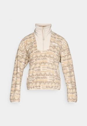 Beige fleece genser med mønster som har geometriske former i brunt og gult, halv glidelås og lange ermer.