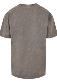Gray, short-sleeve T-shirt with a ribbed texture, slightly faded appearance, and a round neckline. No graphics or additional details.
