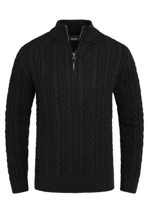 Black cable-knit sweater with long sleeves, ribbed cuffs and hem, and a short front zipper on a stand collar.