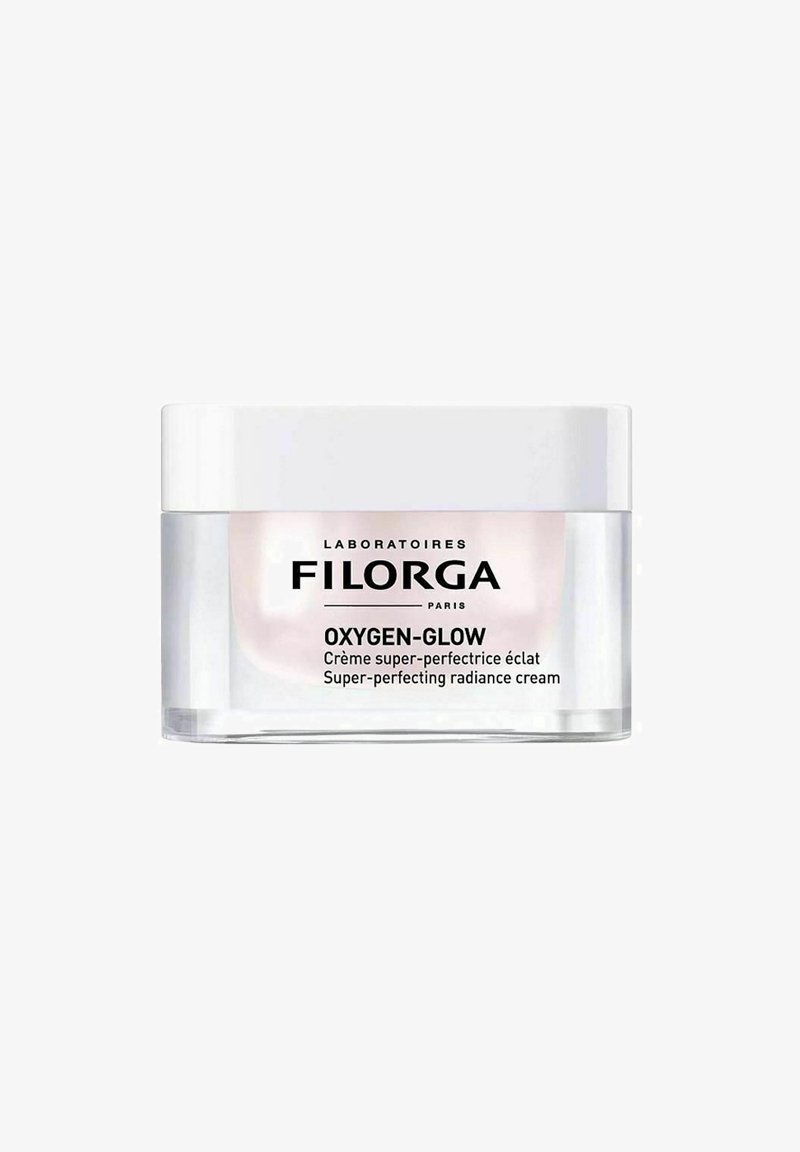 Filorga OXYGEN-GLOW cream in a transparent jar with a white lid. The text features black branding and product details on the front.