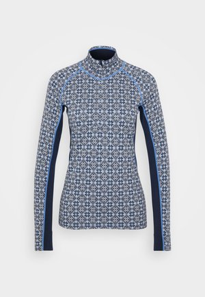 Långärmad topp i blått mönstrat tyg med en diamantdesign och blommönster. Har enfärgade marinblå sidopaneler och en hög krage.