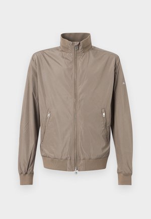 Svetlohnedá bunda na zips so stojacím golierom, dvoma prednými vreckami na zips, žebrovanými manžetami a lemom na jednoduchom pozadí.