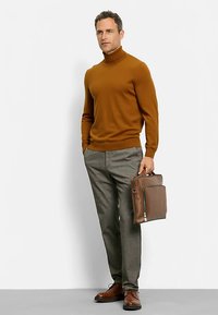 Brown turtleneck sweater, gray patterned trousers, brown leather shoes, and a brown briefcase with zippers and handles. Neutral background.