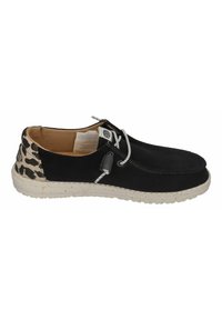Black canvas shoe with a leopard print heel, white speckled sole, and gray laces featuring a pull tab for easy access.
