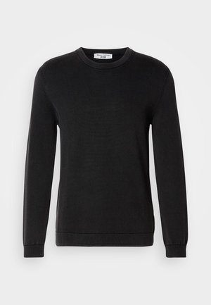 Black long-sleeve crewneck sweater with ribbed cuffs and hem, fine knit texture, and a small brand label inside the collar.