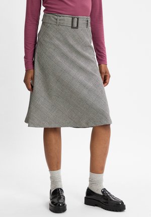 Gray plaid skirt with an A-line shape, featuring a wide belt with a square buckle. Fabric has a textured finish, paired with black shoes and gray socks.