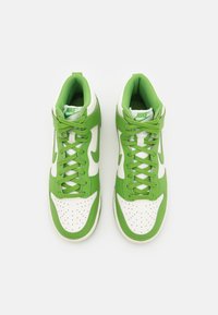 Green and white high-top sneakers with a perforated toe box, lace-up design, padded collar, and bold Nike branding on the tongue.