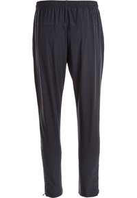 Zwarte, lichte broeken met een elastische tailleband en taps toelopende enkels. Gladde textuur, minimalistisch ontwerp en geen zichtbare hardware.