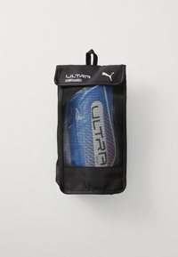 PUMA Ultra shinguards in a black mesh bag with a top handle; shinguards feature blue and red accents with "ULTRA" in bold gray letters.