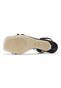 Black heeled sandal with a smooth leather upper and a beige rubber sole. Features an open toe and a textured grip on the sole.