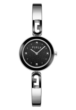 Montre en métal argenté avec un cadran ovale, un cadran noir texturé présentant un motif de logo, des aiguilles des heures et des minutes argentées, et des rivets décoratifs.