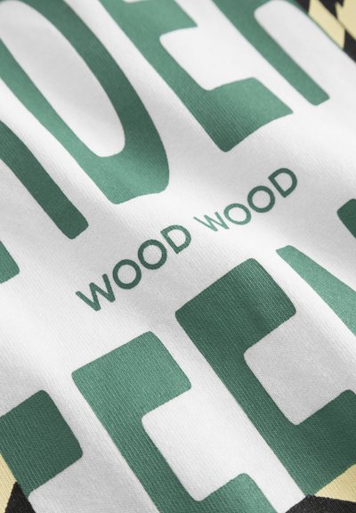 Cotton T-shirt with a white base featuring large green block letters "LOVE" and "WOOD WOOD" printed on the fabric in a smooth texture.