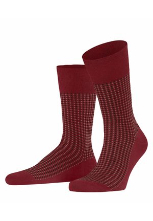 Knee-length socks in dark red with a textured pattern of small black dots. Smooth knit material with ribbed cuffs for secure fit.