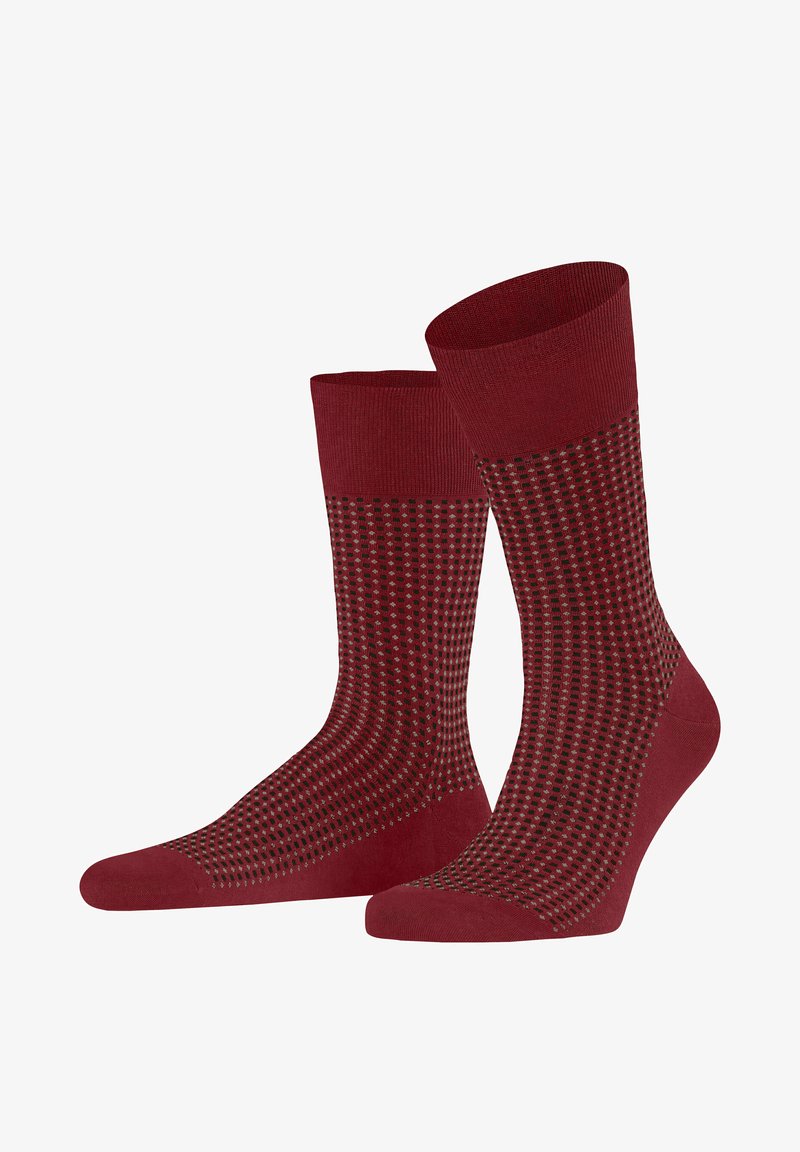 Knielange Socken in Dunkelrot mit einem strukturierten Muster aus kleinen schwarzen Punkten. Glattes Strickmaterial mit gerippten Bündchen für einen sicheren Sitz.