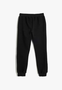 Zwarte gebreide joggingbroek met een elastische tailleband en tapered cuffs. Gewatteerde stof met een subtiel patroon throughout.