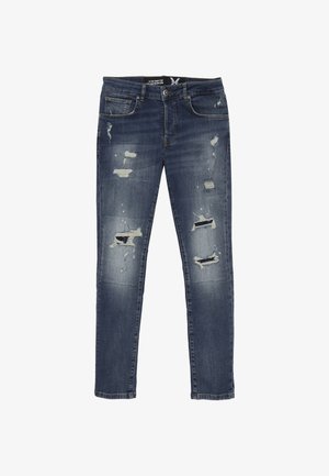 Jeans skinny blu scuro sbiaditi con strappi consumati, design a cinque tasche e chiusura con bottone. L'orlo è leggermente sfilacciato.