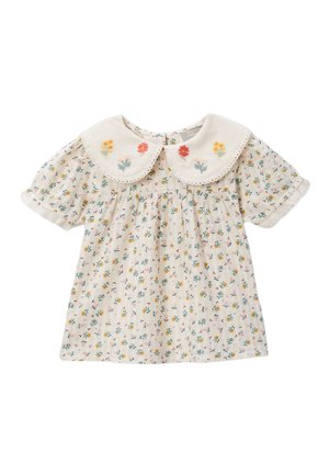 Blouse pour bébé couleur crème avec un petit imprimé floral jaune, rose et vert, manches courtes bouffantes et large col Peter Pan brodé.