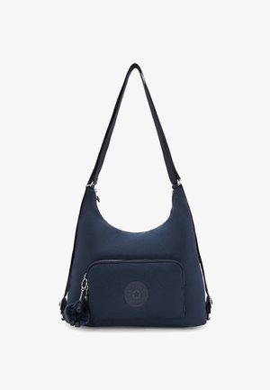 Marineblauwe nylon schoudertas met een ronde vorm, verstelbare schouderband, een voorzak met rits en een pluizige aap sleutelhanger als accent.