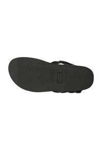 Sole di sandalo in gomma nera con un motivo a zigzag testurizzato, con logo inserito. Il design è piatto, creando trazione per stabilità.