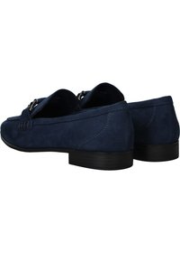 Navy blue suede loafers with stitched detailing and silver hardware accents, featuring a low black heel and smooth texture.