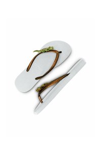 Flip-flops with a textured white sole, brown straps, and green lizard accents. Features a prominent design on the straps.