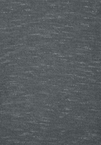 Dunkelgrauer gestrickter Stoff mit einer subtilen Textur und hellen Sprenkeln, der ein durchgängiges Muster auf dem Material aufweist.