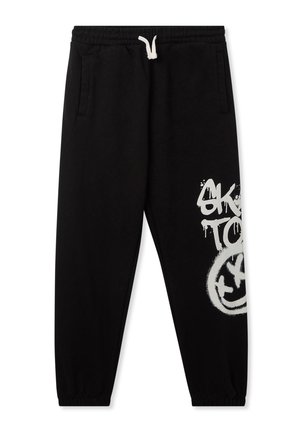 Pantaloni joggers neri in cotone con vita elasticizzata e cordino. Presentano tasche laterali e una grafiche in stile graffiti bianco sulla gamba destra.