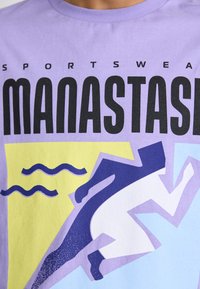 Purple cotton t-shirt featuring bold black text "SPORTSWEAR MANASTASH" and vibrant graphic of a runner against yellow and blue background.