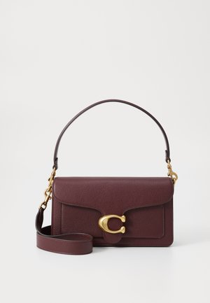 Burgundy leather handbag with a gold-tone circular clasp, featuring a structured shape, short handle, and detachable shoulder strap.