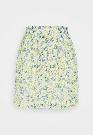 Jupe plissée blanche avec imprimé floral bleu et jaune et une ceinture cintrée, présentée sur fond blanc.