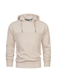 Beige hættebluse lavet af struktureret stof med et front-seam panel, justerbare snore og lange ærmer. Har en ribbet kant og manchetter.