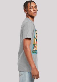 Gray cotton t-shirt featuring a colorful graphic print on the front, depicting comic-style characters. Short sleeves, relaxed fit.