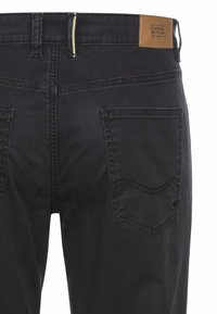 Black cotton denim jeans with a straight fit, featuring a tan leather patch at the waist and two back pockets with stitched detailing.