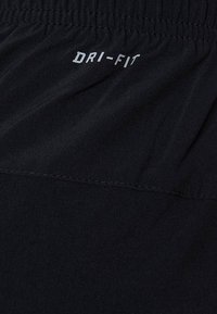 Black Dri-FIT shorts with an elastic waistband. The fabric is smooth with a subtle sheen, featuring stitched detailing and logo.