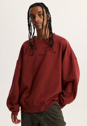Maroon oversized sweatshirt made of soft fabric, featuring a subtle embroidered "VANS" logo on the front and relaxed fit with wide sleeves.