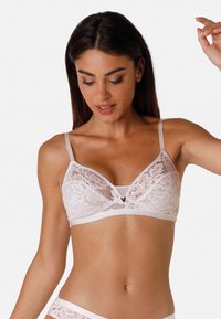 Bralette in pizzo rosa chiaro con spalline regolabili, design floreale, coppe morbide senza imbottitura e un elastico in satin. Bordo delicatamente scallopato.