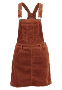 Robe salopette en velours côtelé marron avec bretelles ajustables, poche avant, boutons latéraux et un ourlet effiloché. Le tissu texturé ajoute de la profondeur.