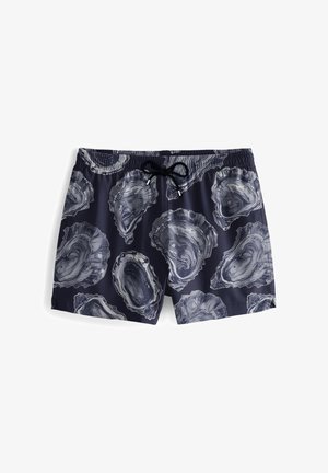 Marineblaue Badetaschen mit einem Muschelmuster in Grau. Mit einem elastischen Bund und einem schwarzen Kordelzug für eine verstellbare Passform.