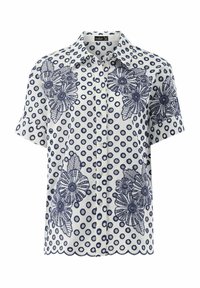 Camicia bianca a maniche corte con pois navy e motivi floreali ricamati. Orlo ondulato con chiusura frontale a bottoni.